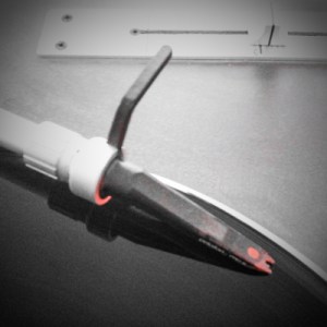 Photo by Ian Campbell of a Vestax PDX-1As turntable and an Ortofon Concorde headshell with stylus.